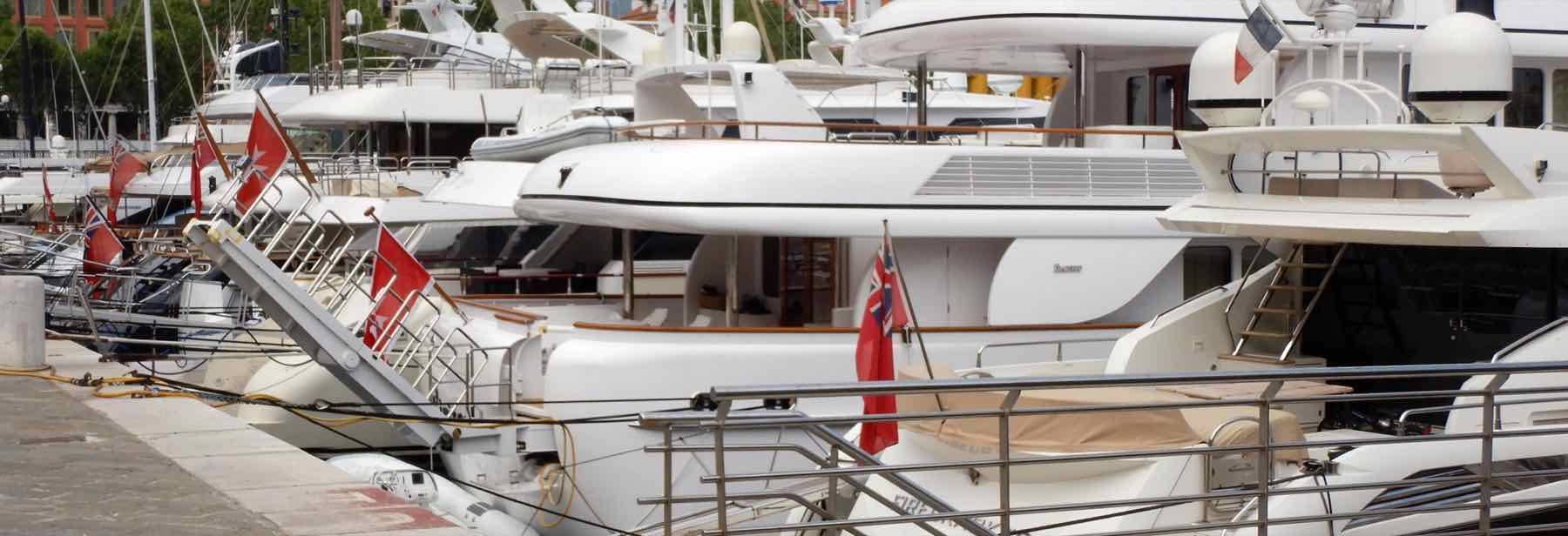 Large motor yachts moored along the quays of the port of Nice