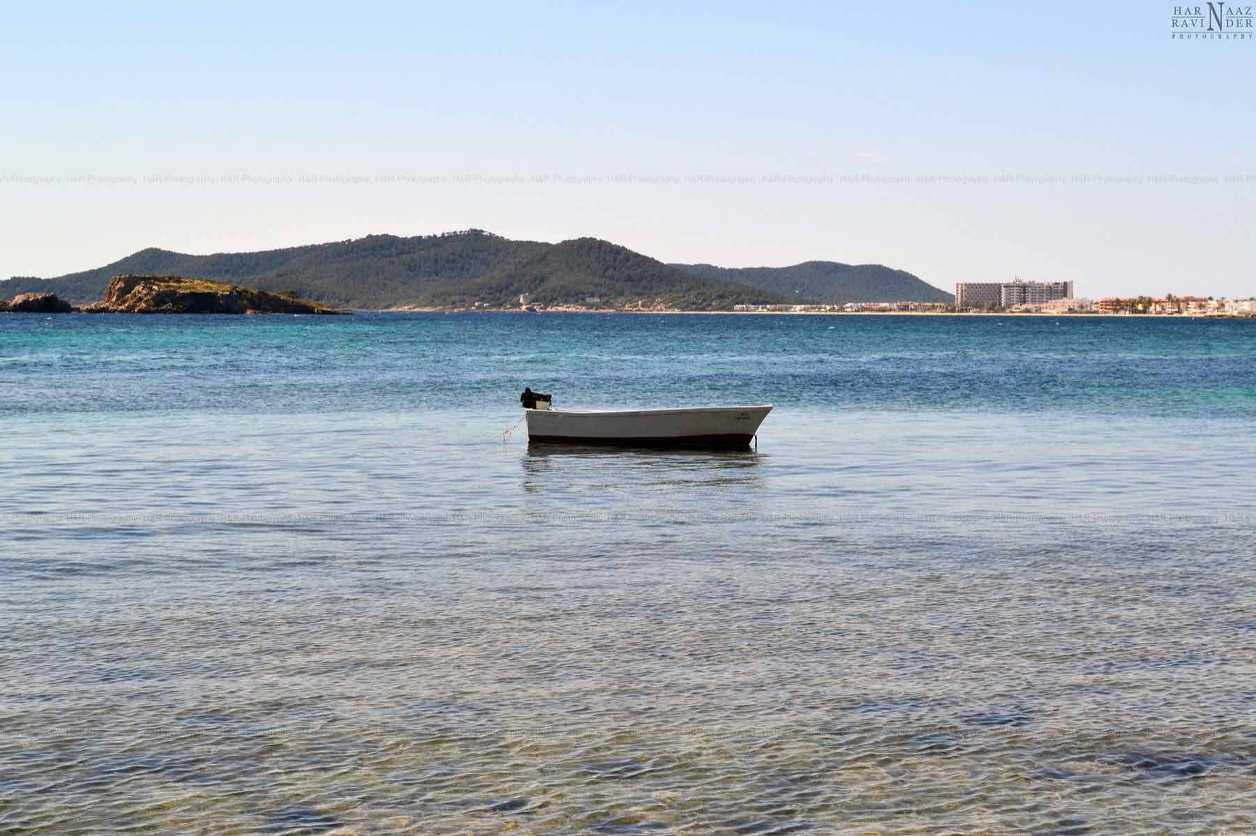 The coast of Ibiza with boats moored in a bay